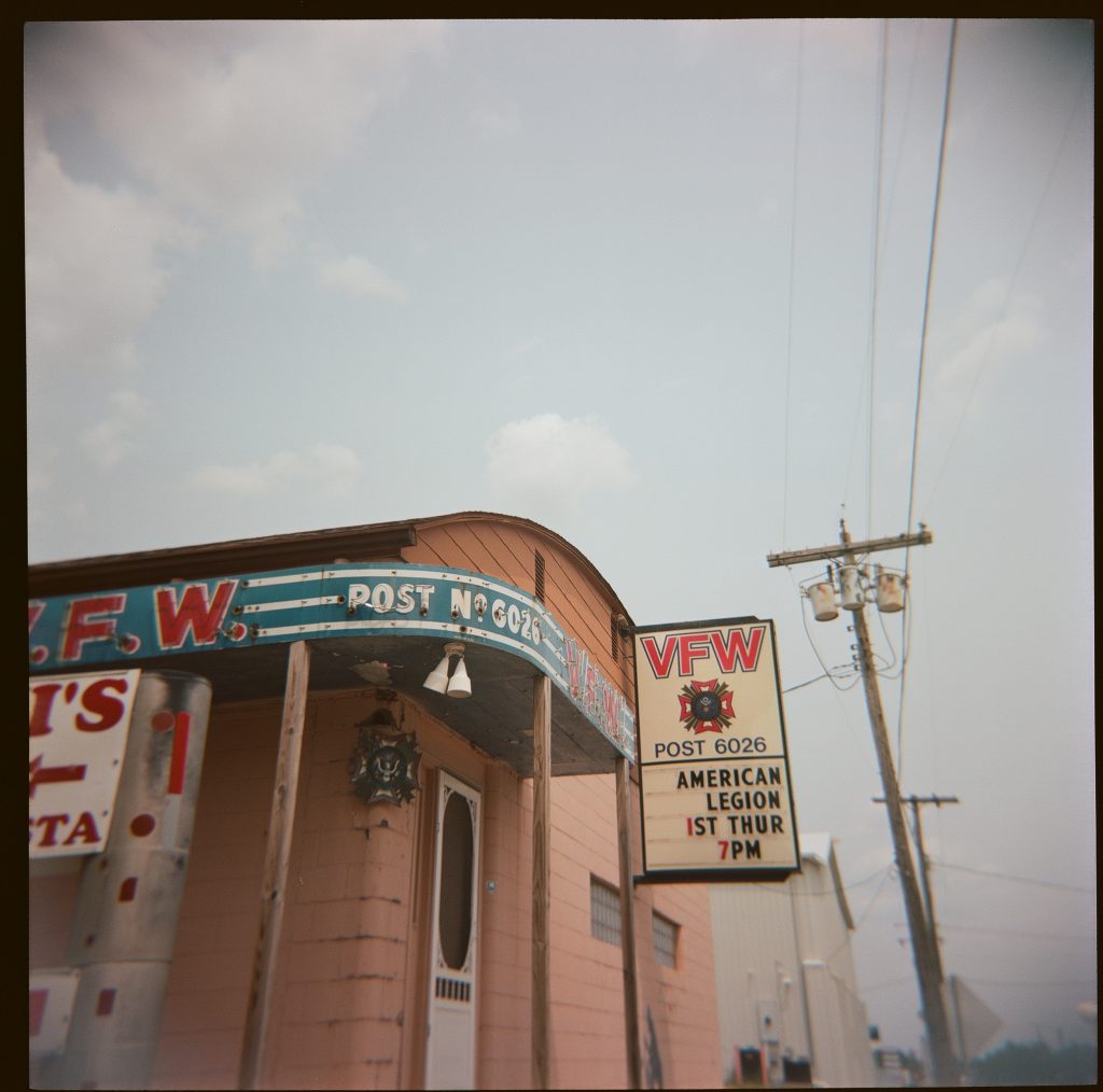 Clouds and an old VFW location and neon sign
