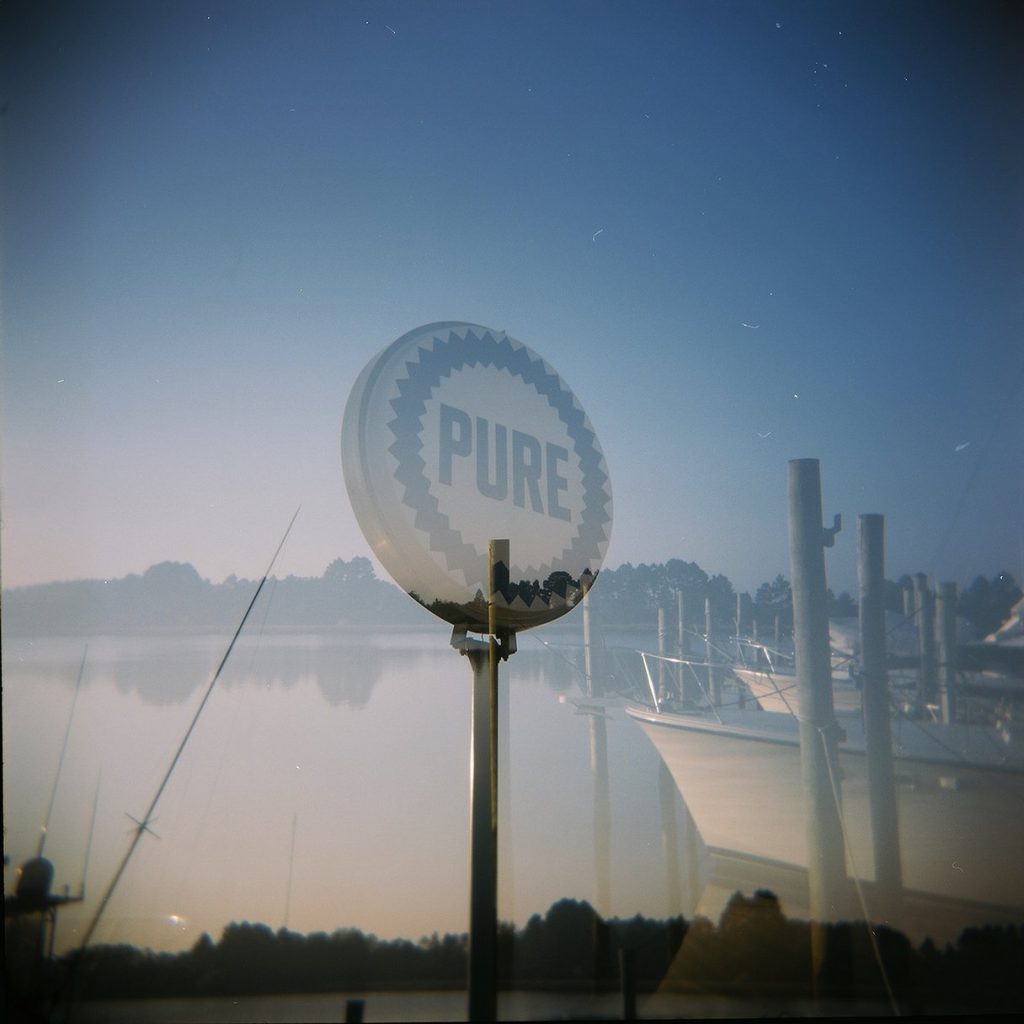 Ships in the background of a Pure Oil sign